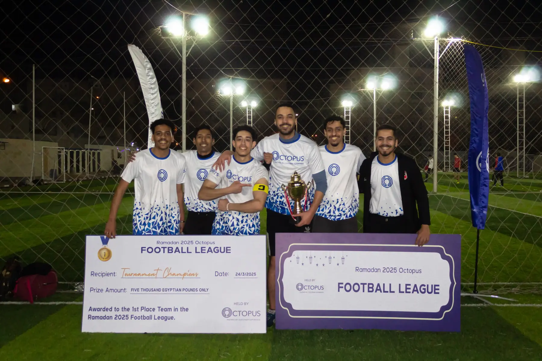 The winning team of the Octopus football league with their trophy